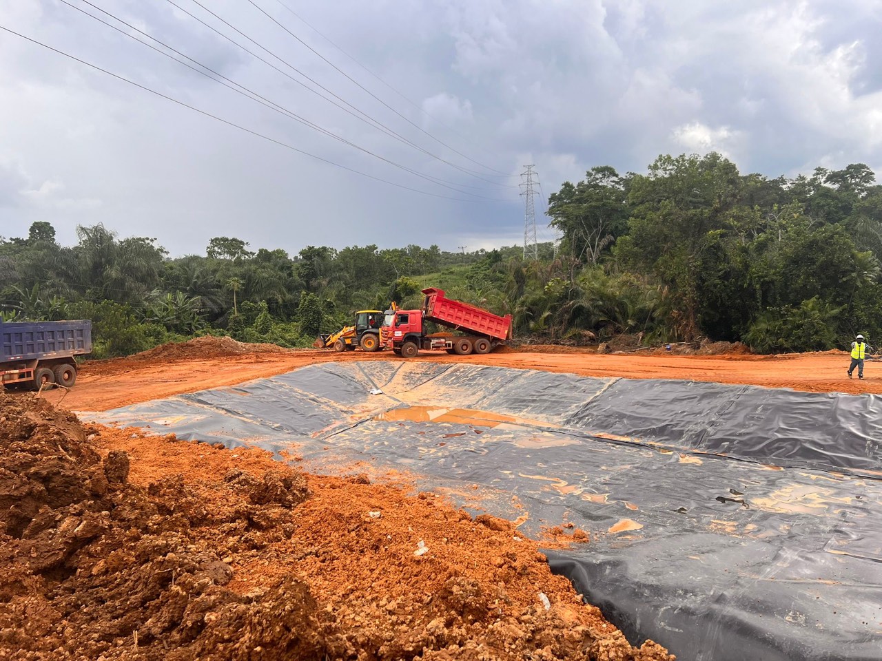 A lined settling and storage pond under construction
